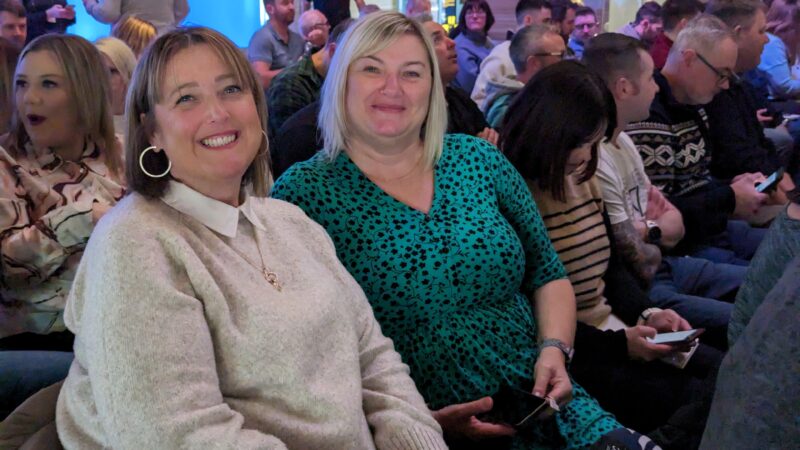 two ladies smiling at a Coastal staff conference